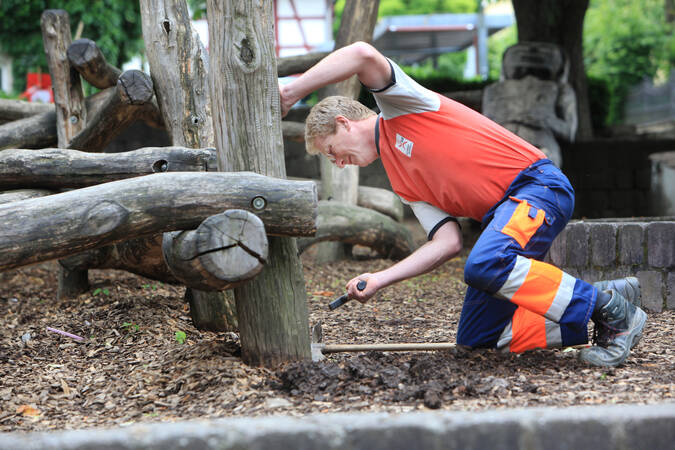 Mitarbeiter befestig Kletterstämme aus Holz